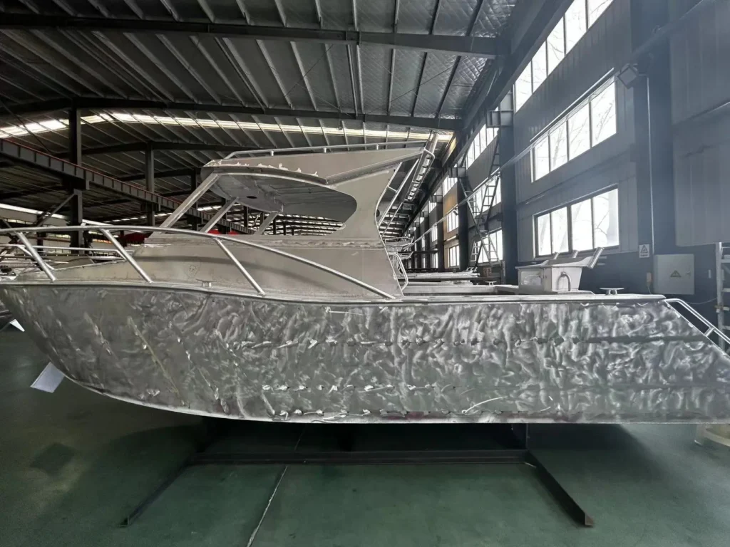 Bare aluminium boat hull inside the production facility