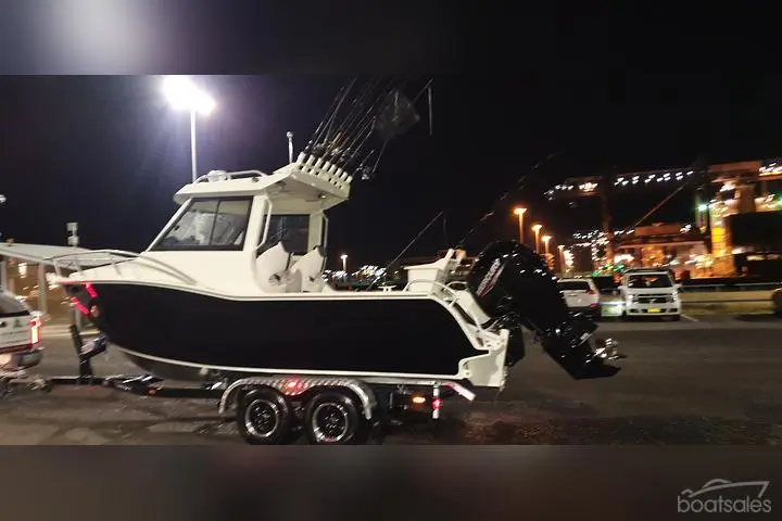 Plate aluminium hardtop cabin boat on a trailer at night
