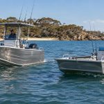 Deep V aluminium fishing boat cutting through coastal chop