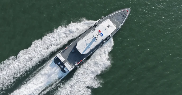Aerial view of a plate aluminium patrol boat at speed