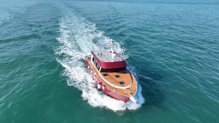 Aerial view of a plate aluminium work boat under way