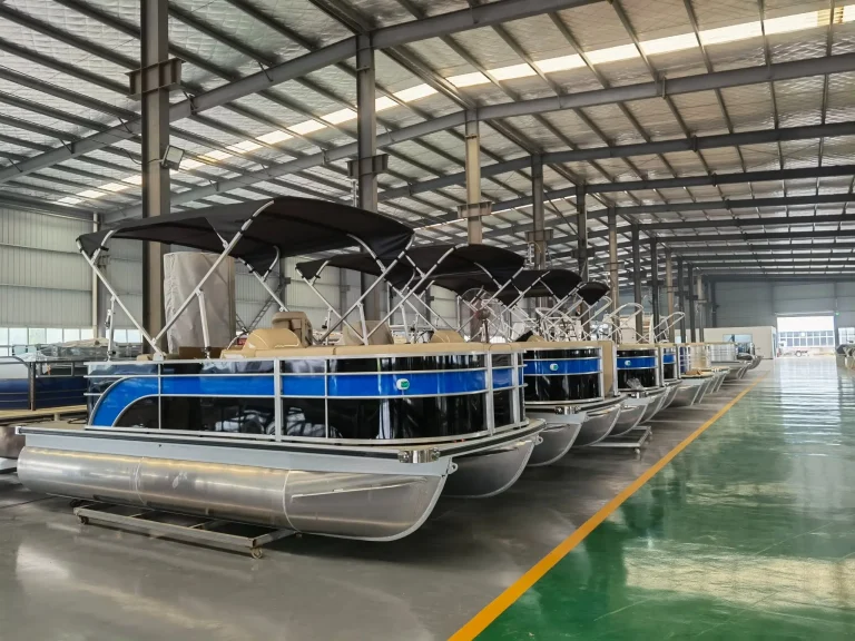Aluminium pontoon boat with bimini top awaiting delivery