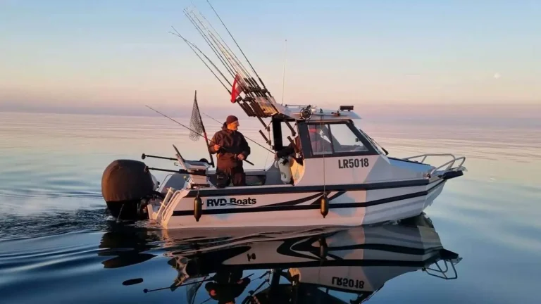 Anglers fishing from a plate aluminium boat at sunset