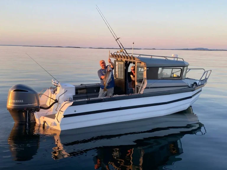 Anglers on a plate aluminium boat at sunset