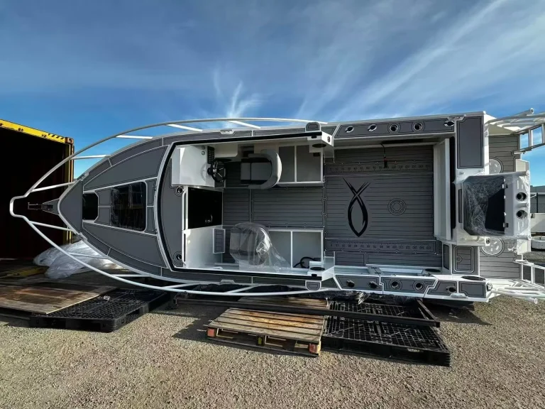 Bare aluminium cabin boat outside the workshop