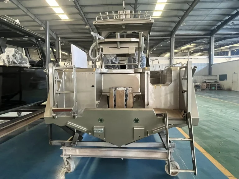 Bare aluminium hull with deck hardware in the factory