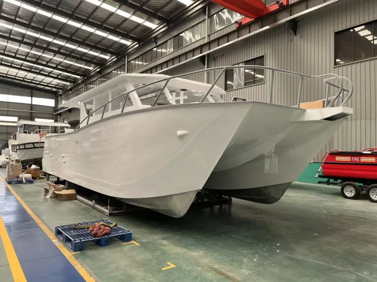Bare aluminium hull with flared bow in the factory