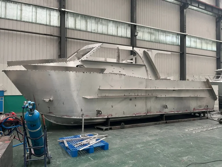 Bare aluminium work boat hull in the factory