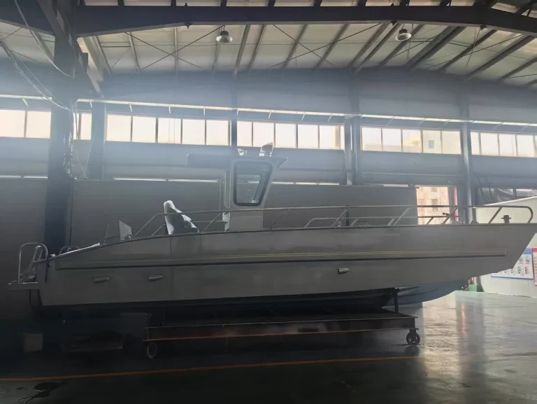 Bare aluminium work boat hull in the shed