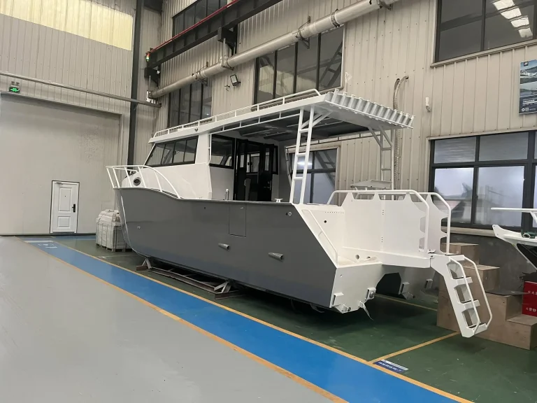 Bare aluminium work boat with bow ramp in the factory