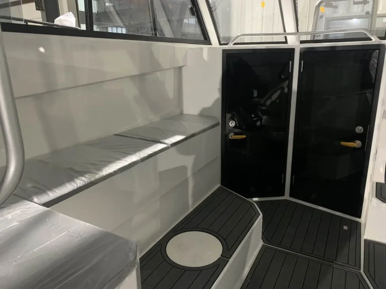 Bare cabin interior with bench seat and side windows
