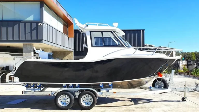 Black and white plate aluminium hardtop boat on a trailer