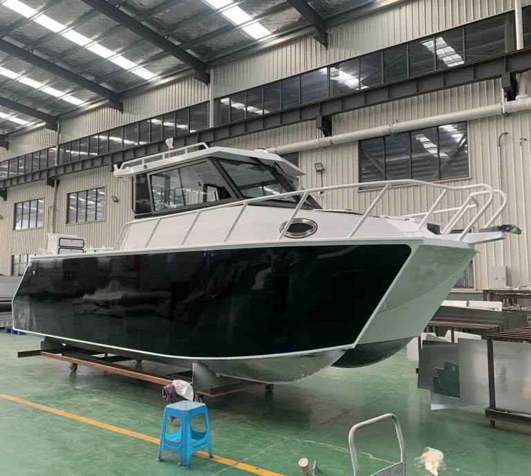 Black hulled hardtop cruiser with white cabin on stands