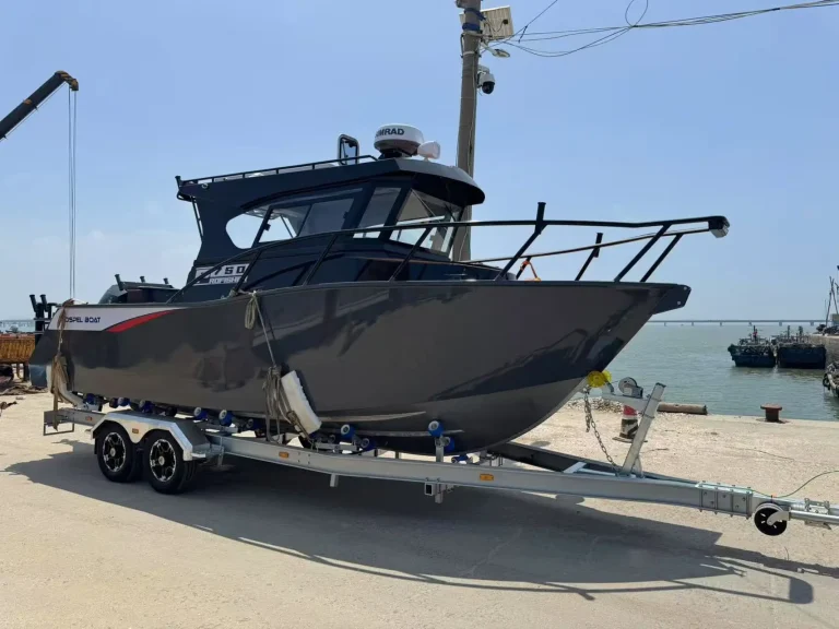Black patrol boat on a trailer at the water's edge