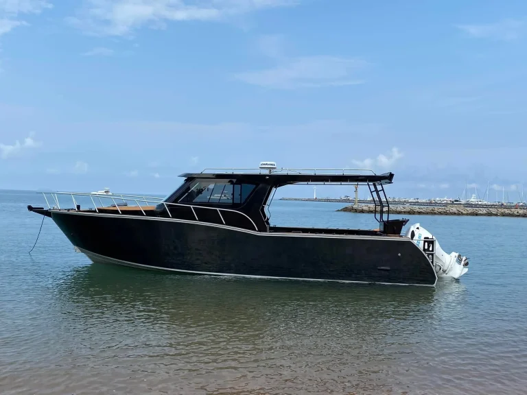 Black plate aluminium cabin boat drifting on flat water