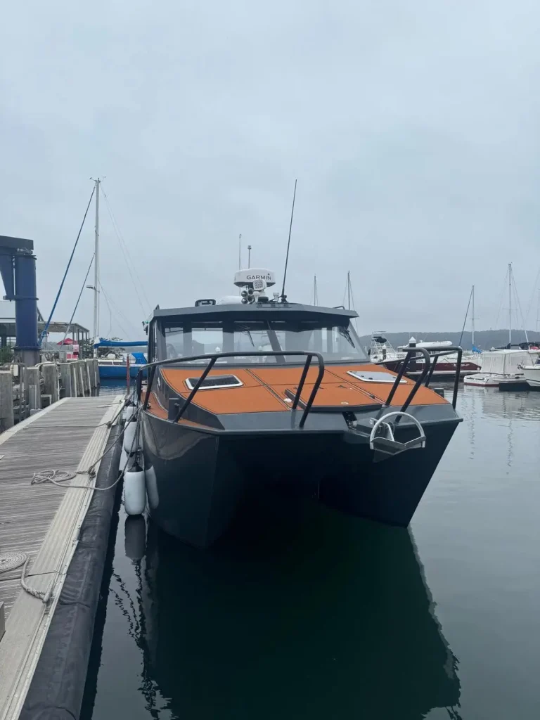 Black plate aluminium cruiser berthed at a marina