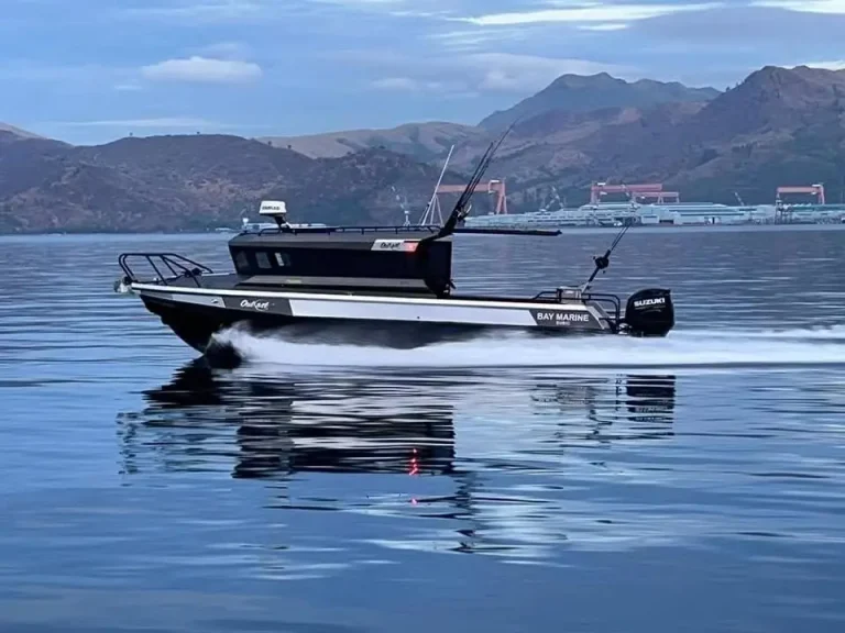 Black plate aluminium hardtop boat underway on a calm bay