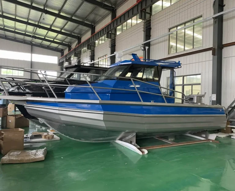 Blue and silver plate aluminium hardtop boat on the factory floor