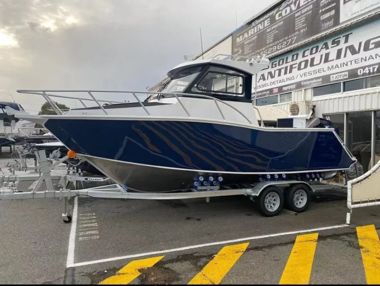 Blue plate aluminium hardtop boat on a trailer at the dealership