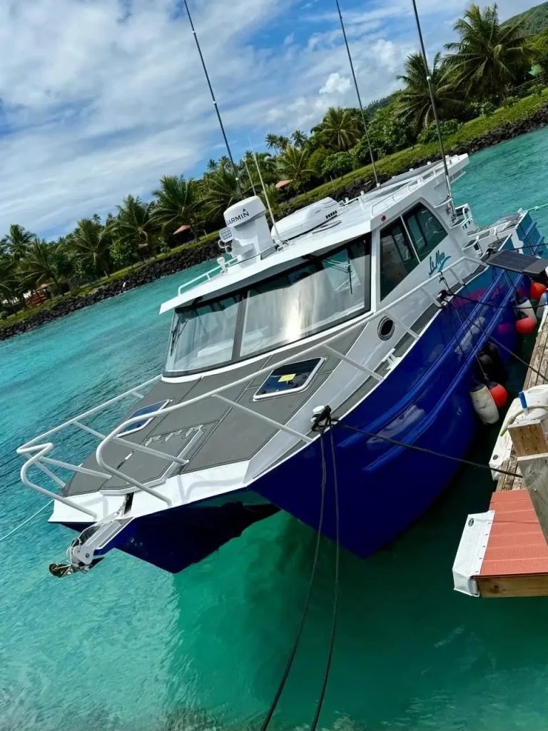 Bow of a blue plate aluminium boat on turquoise water
