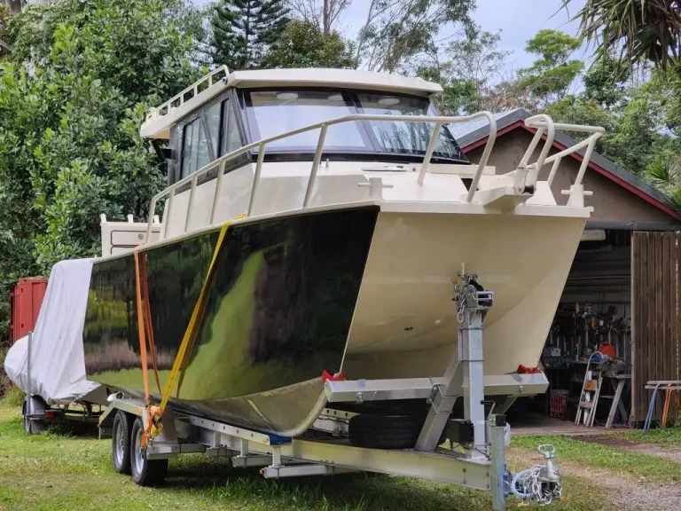 Bow of a hardtop plate aluminium boat on its trailer
