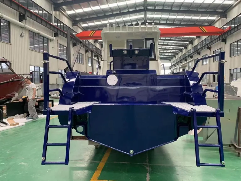 Bow on view of a navy plate aluminium hull on the factory floor