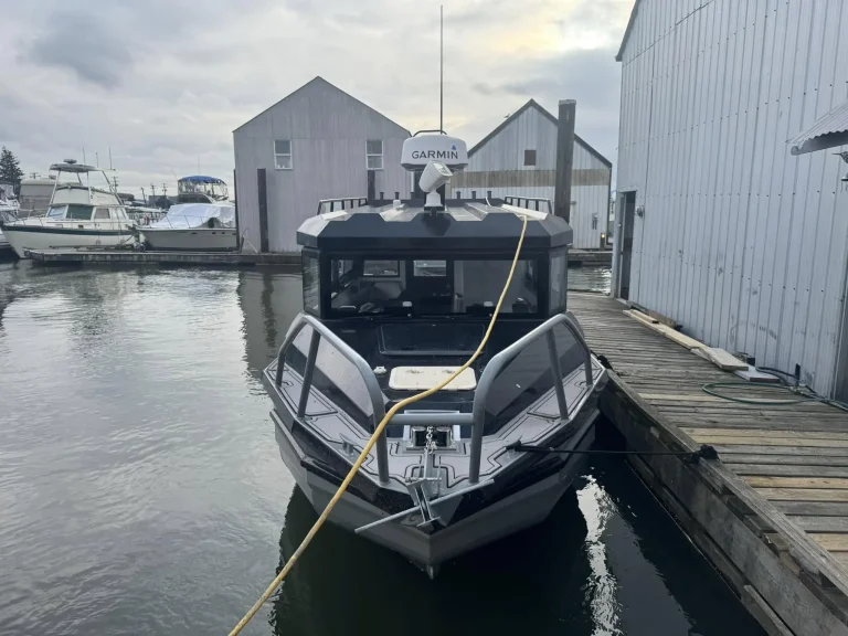 Bow on view of a plate aluminium cabin boat at a marina