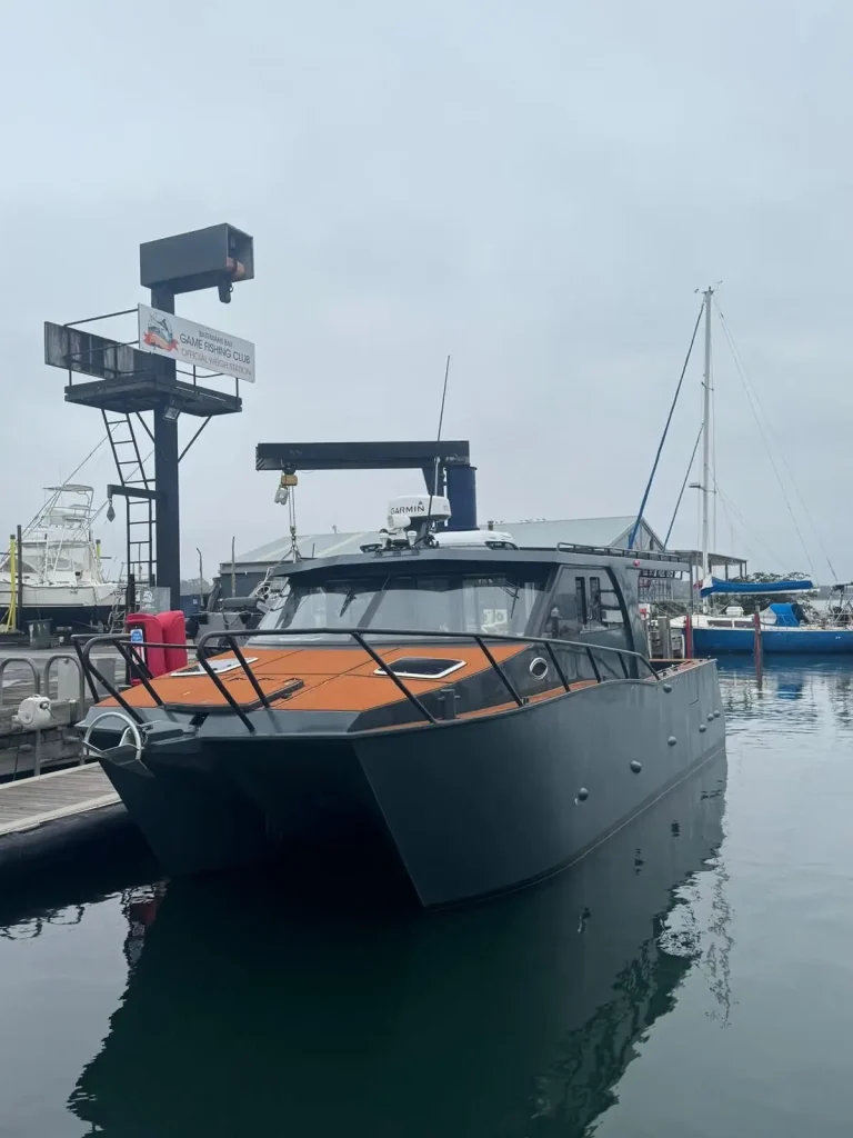 Bow view of a black plate aluminium cruiser at the wharf