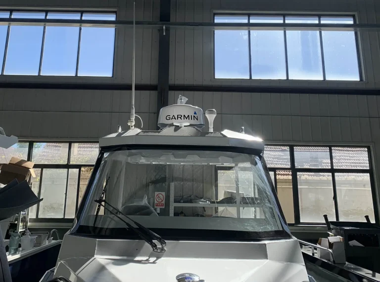 Bow view of a white hardtop cabin boat with Garmin electronics
