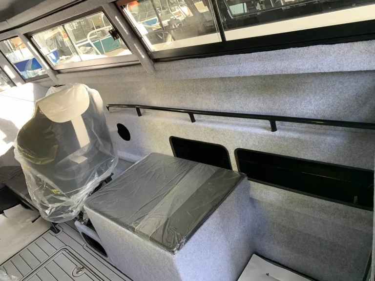 Cabin bench seat and helm under protective wrap