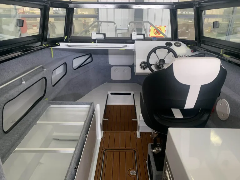Cabin helm seat and side windows before fit out