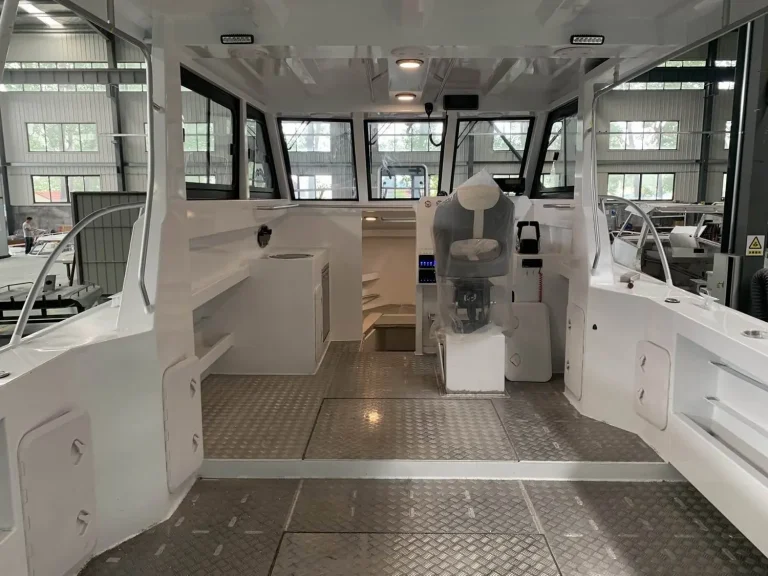 Cabin interior looking aft with helm seats and teak look floor