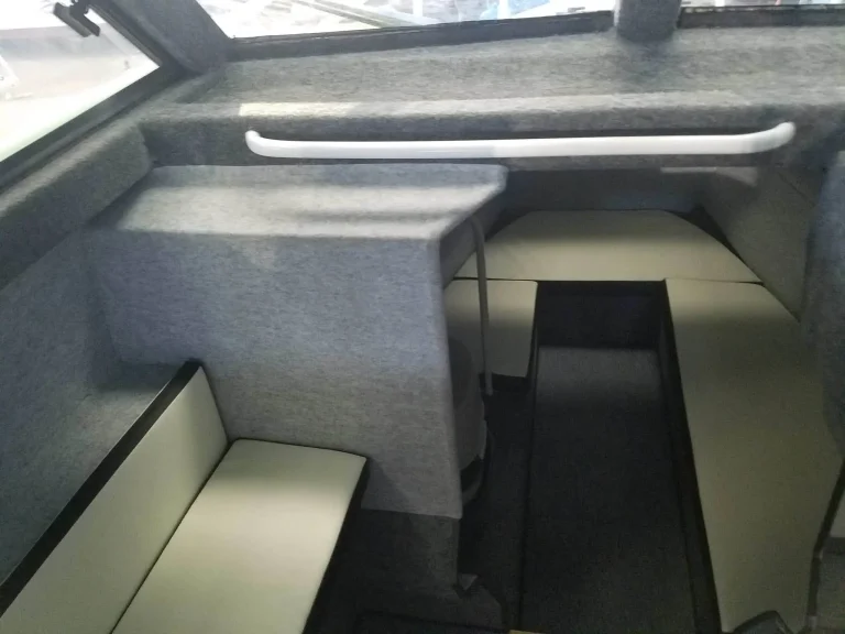 Cabin interior with bench seat and grey lining