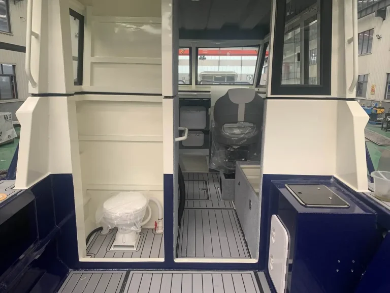 Cabin interior with enclosed marine toilet and side windows