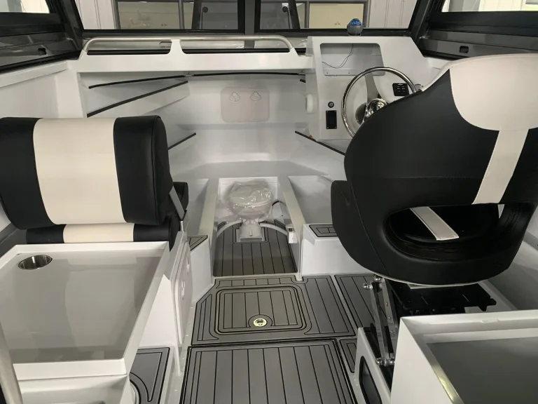 Cabin interior with helm seat and teak look flooring
