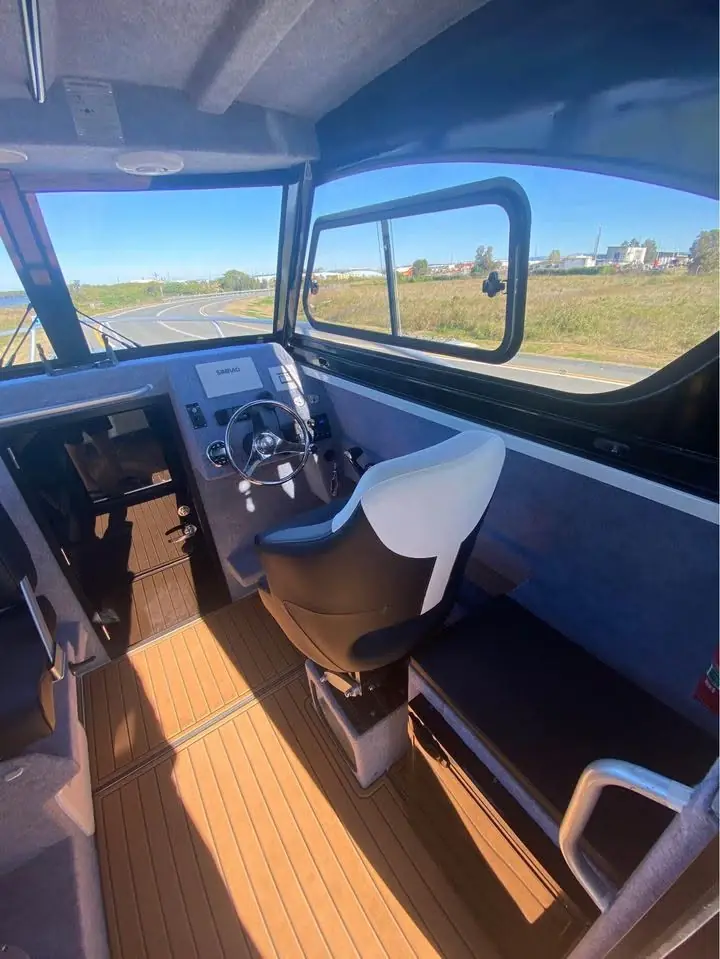 Cabin interior with timber look floor and helm seats