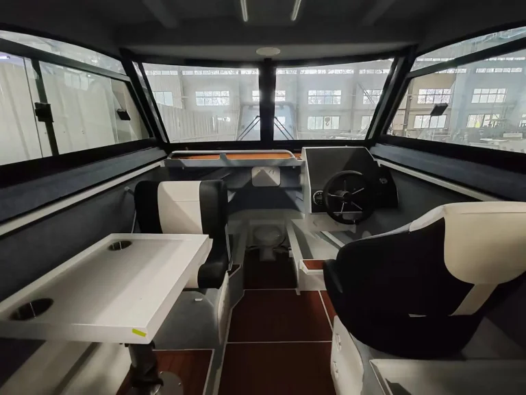 Cabin interior with timber table and helm seat