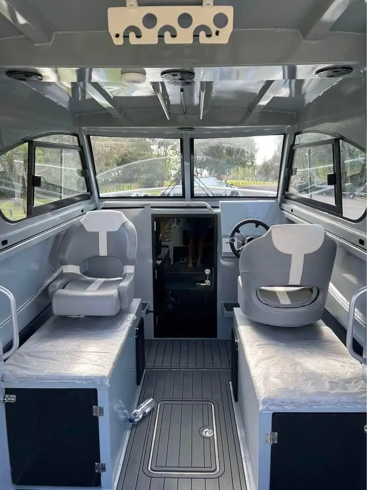 Cabin interior with twin seats and teak look flooring