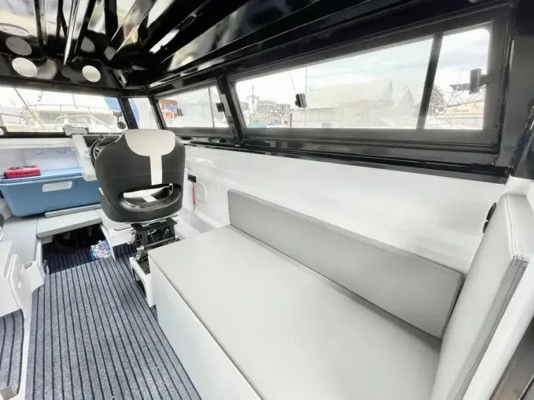 Cabin interior with white upholstery and teak look floor