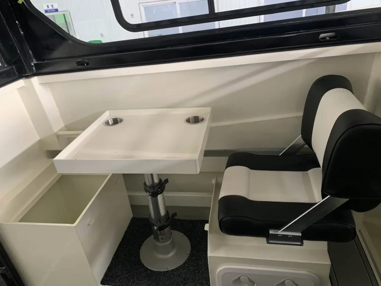 Cabin table and seating inside a plate aluminium boat