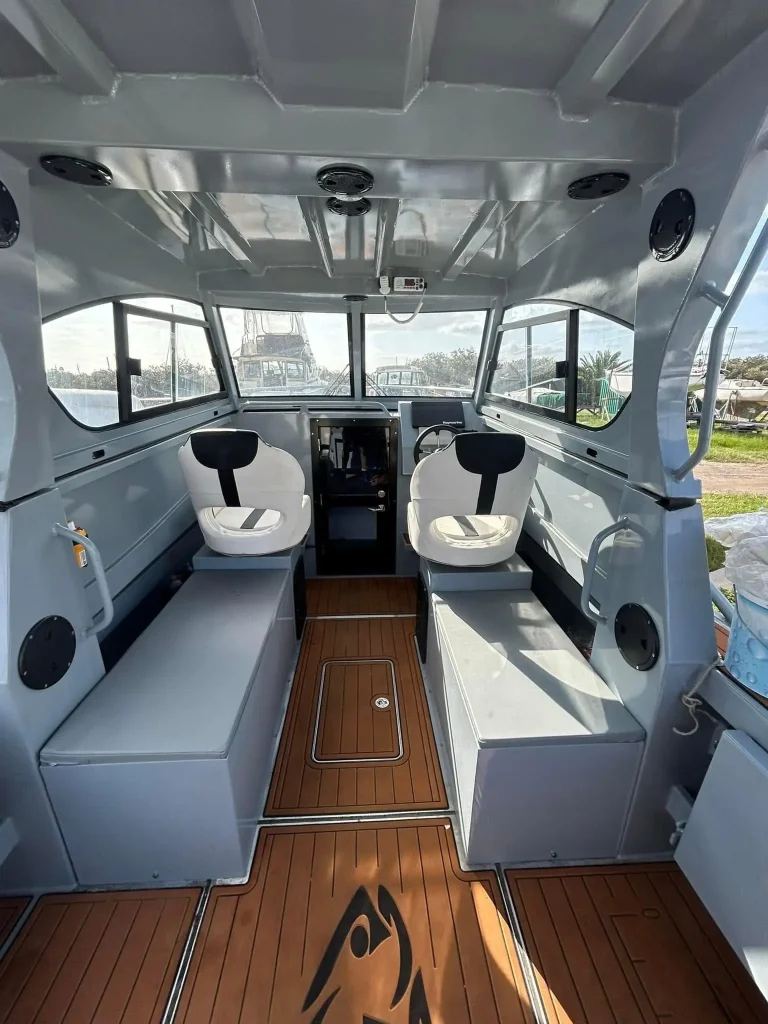 Cabin with white seats and teak look flooring