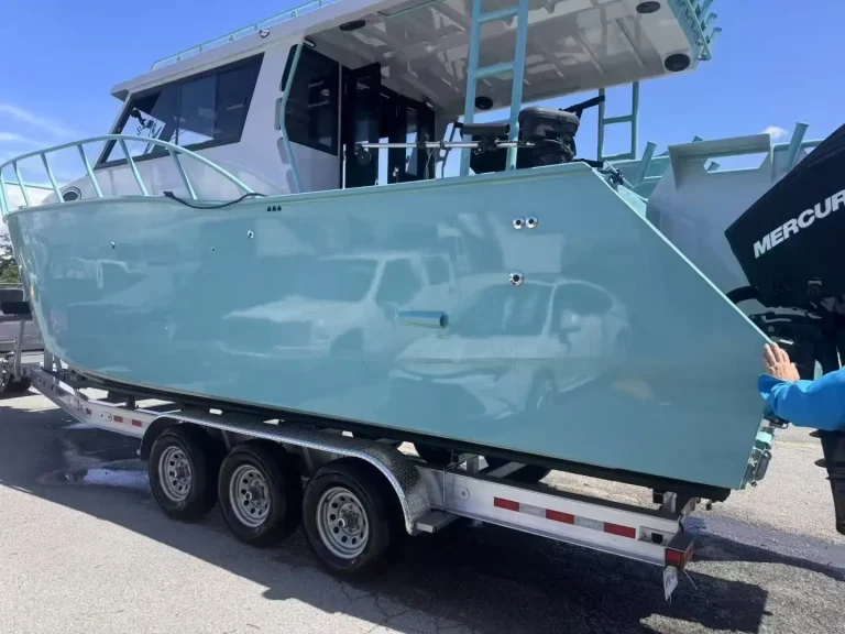 Camouflage wrapped plate aluminium boat on a trailer