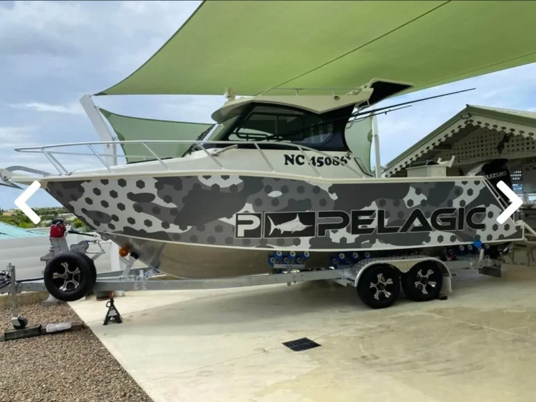 Camouflage wrapped plate aluminium boat on a trailer