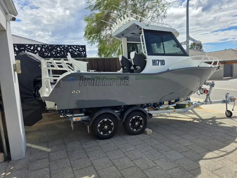 Charcoal plate aluminium hardtop boat on a trailer