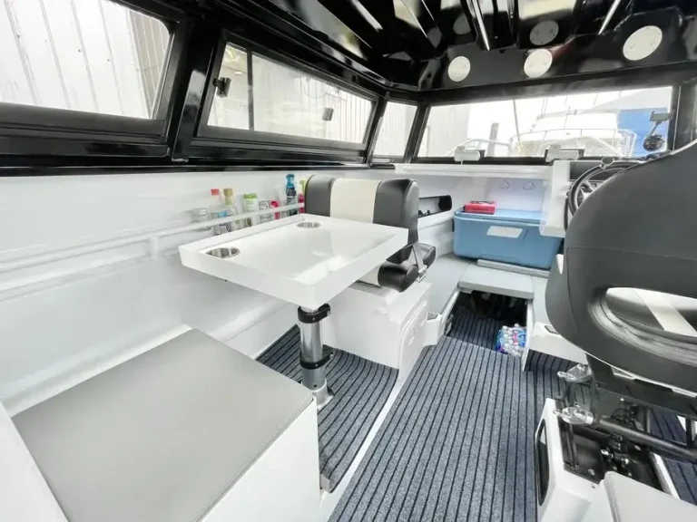 Cockpit with white seat modules and teak look floor