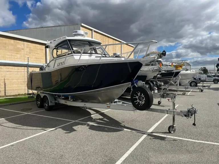 Dark hulled hardtop plate aluminium boat on a trailer