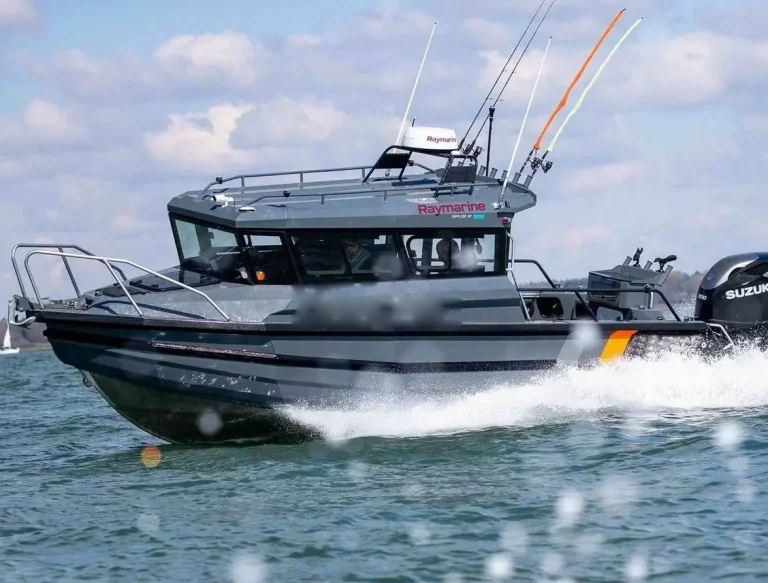 Dark hulled plate aluminium boat running with outboards