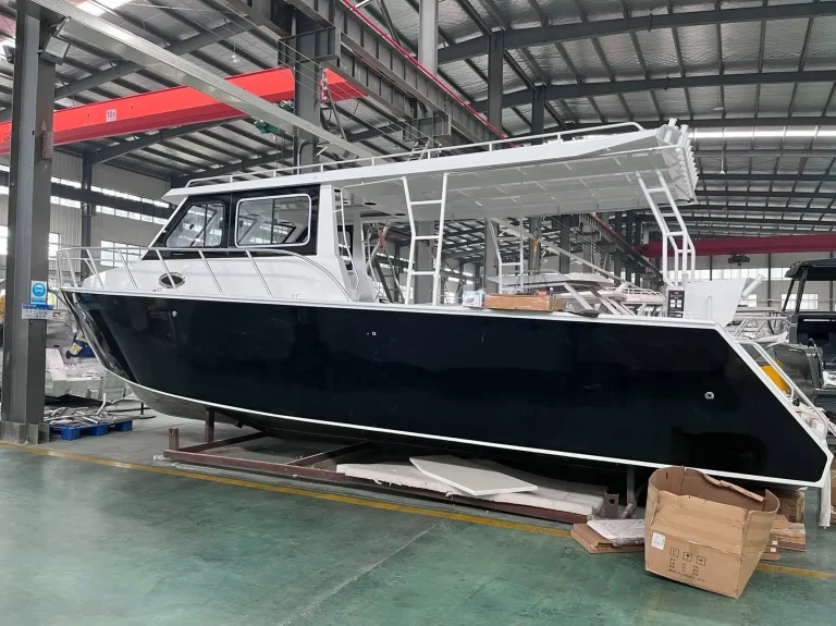 Dark hulled plate aluminium hardtop boat inside the factory