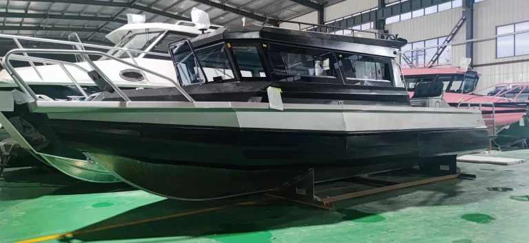 Dark hulled plate aluminium hardtop boat on the factory floor