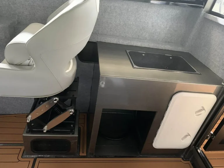 Fold up helm seat and deck storage hatch with teak look flooring